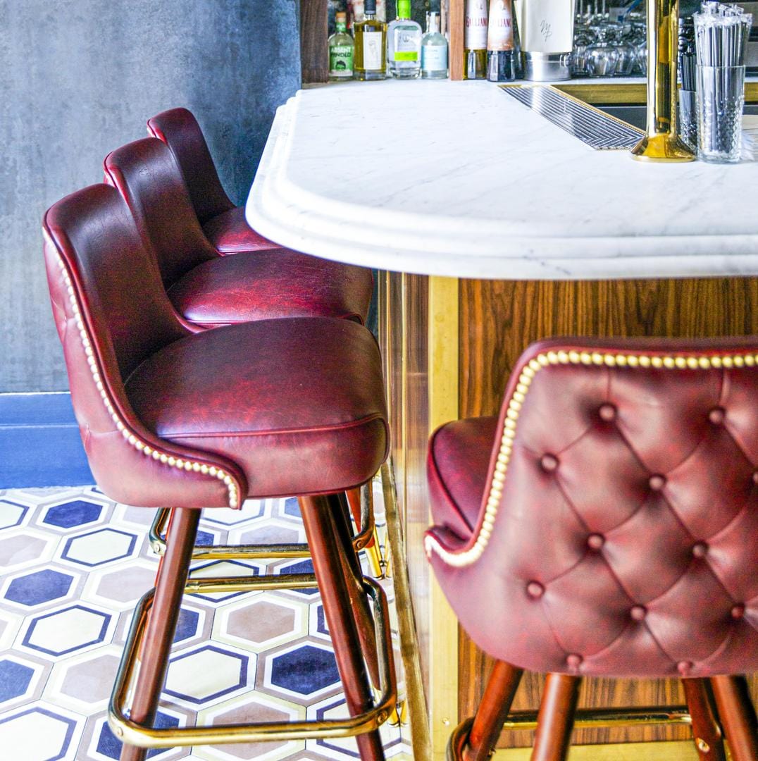 bar counter corner showing classic tufted button bar stools