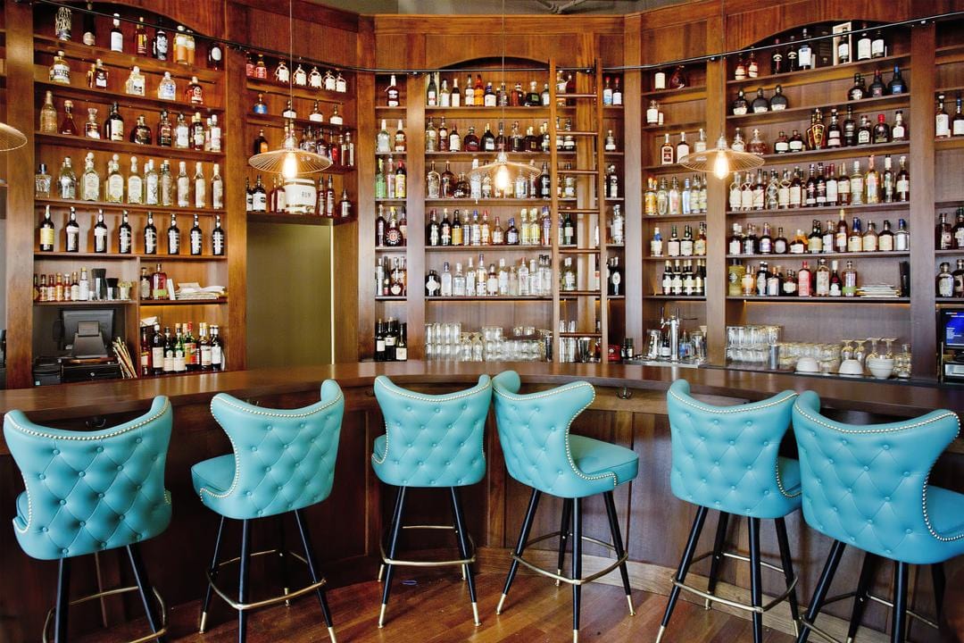 colourful bar stools in wooden classic bar