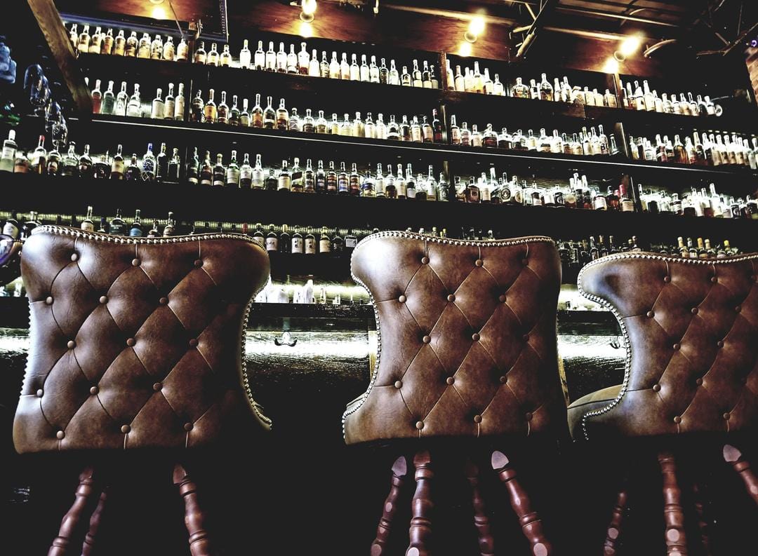 bar with brown classic tufted button back bar stools